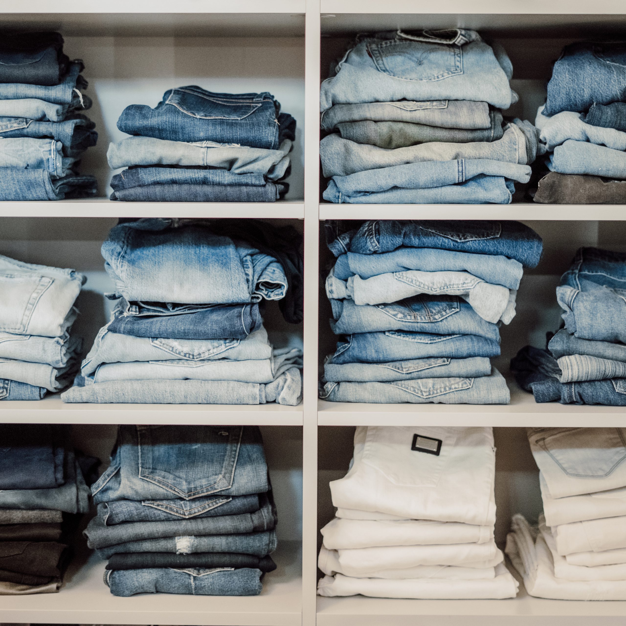 Neatly folded clothes in an organized closet
